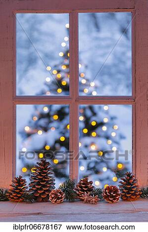 Stock Photo - Window with view of illuminated Christmas tree. Fotosearch