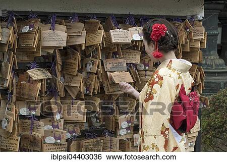 Woman dressed in traditional kimono looks at Ema wish plaques at Ueno Toshogu Shrine, Tokyo, Japan, Asia View Large Photo Image Stock Photograph - Woman dressed in traditional kimono looks at Ema wish plaques at Ueno Toshogu Shrine, Tokyo, Japan, Asia. Fotosearch