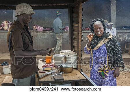 Woman eating grilled meat at street stand, street scene, Bamenda, North-West Region, Cameroon, Africa View Large Photo Image Stock Image - Woman eating grilled meat at street stand, street scene, Bamenda, North-West Region, Cameroon, Africa. Fotosearch