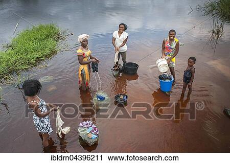 Women washing clothes by the river Ntem in the rainforest, Campo, Southern Region, Cameroon, Africa View Large Photo Image Stock Image - Women washing clothes by the river Ntem in the rainforest, Campo, Southern Region, Cameroon, Africa. Fotosearch