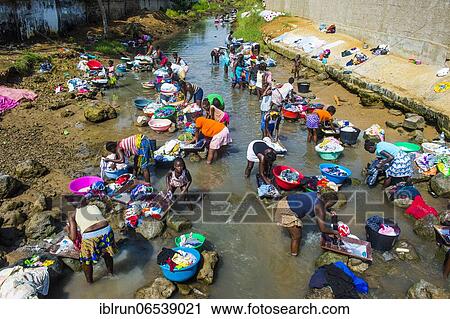 Women washing clothes in a river bed, City of Sao Tome, Sao Tome and Principe, Atlantic ocean, Africa View Large Photo Image Stock Image - Women washing clothes in a river bed, City of Sao Tome, Sao Tome and Principe, Atlantic ocean, Africa. Fotosearch