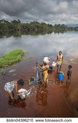 Women washing clothes in the river Ntem, in the rainforest, Campo, Southern Region, Cameroon, Africa View Large Photo Image Stock Image - Women washing clothes in the river Ntem, in the rainforest, Campo, Southern Region, Cameroon, Africa. Fotosearch