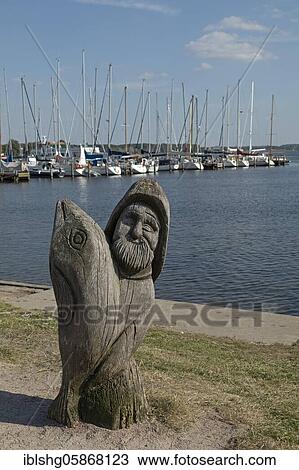 Wooden figure of a fisherman with fish at the marina, Baltic resort Rerik, Mecklenburg-Vorpommern, Germany, Europe View Large Photo Image Stock Image - Wooden figure of a fisherman with fish at the marina, Baltic resort Rerik, Mecklenburg-Vorpommern, Germany, Europe. Fotosearch