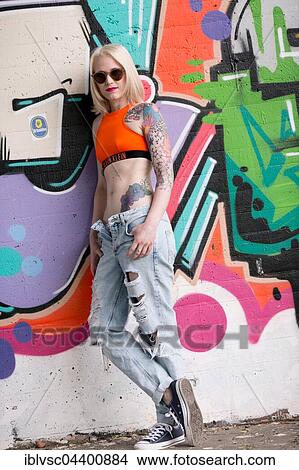 Picture - Young blond woman, tattooed. Fotosearch