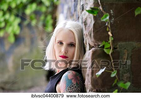 Stock Photo - Young blond woman, tattooed. Fotosearch
