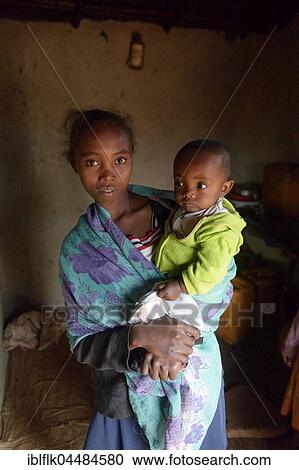 Young mother with toddler, Tsiroanomandidy district, Bongolava region, Madagascar, Africa View Large Photo Image Stock Image - Young mother with toddler, Tsiroanomandidy district, Bongolava region, Madagascar, Africa. Fotosearch