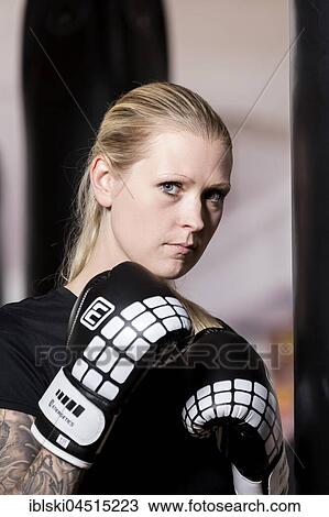 Young woman, tattooed, boxing at a sandsack in a boxing studio, Bavaria, Germany, Europe View Large Photo Image Stock Image - Young woman, tattooed, boxing at a sandsack in a boxing studio, Bavaria, Germany, Europe. Fotosearch