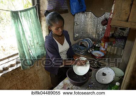 Young woman washes dishes, household, Fianarantsoa province, Madagascar, Africa View Large Photo Image Stock Photography - Young woman washes dishes, household, Fianarantsoa province, Madagascar, Africa. Fotosearch