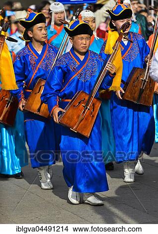 Youth in traditional Deel clothes and horse-head fiddle, Morin chuur, Festival of the Mongolian national costume, Ulaanbaatar, Mongolia, Asia View Large Photo Image Picture - Youth in traditional Deel clothes and horse-head fiddle, Morin chuur, Festival of the Mongolian national costume, Ulaanbaatar, Mongolia, Asia. Fotosearch