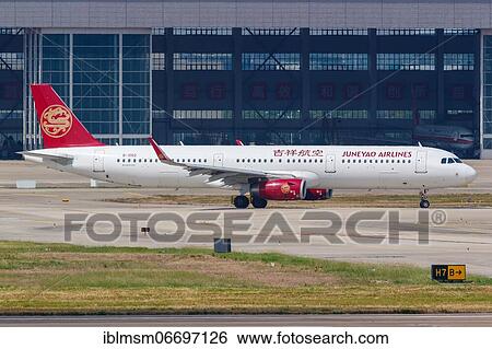 Stock Photograph - A Juneyao Airlines Airbus A321 with registration number B-1002 at Shanghai Hongqiao Airport (SHA), Shanghai, China, Asia. Fotosearch