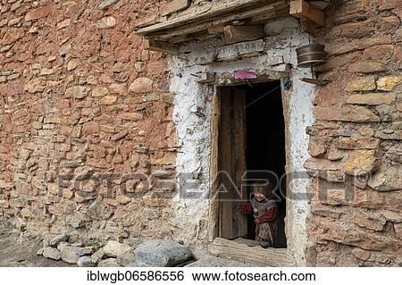 A little boy looking out of a doorway, Shey Gompa, Dolpo, Nepal, Asia View Large Photo Image Stock Photograph - A little boy looking out of a doorway, Shey Gompa, Dolpo, Nepal, Asia. Fotosearch