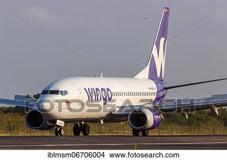 A Wingo Boeing 737-700 aircraft with registration C-GTQG at Cartagena Airport, Colombia, South America View Large Photo Image Picture - A Wingo Boeing 737-700 aircraft with registration C-GTQG at Cartagena Airport, Colombia, South America. Fotosearch
