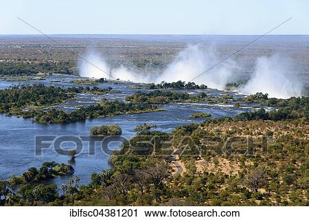 Aerial View, Zambezi river flows into the Victoria Falls, border of Zambia and Zimbabwe, Africa View Large Photo Image Stock Image - Aerial View, Zambezi river flows into the Victoria Falls, border of Zambia and Zimbabwe, Africa. Fotosearch