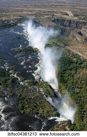 Aerial View, Zambezi river flows into the Victoria Falls, waterfall, border of Zambia and Zimbabwe, Africa View Large Photo Image Stock Image - Aerial View, Zambezi river flows into the Victoria Falls, waterfall, border of Zambia and Zimbabwe, Africa. Fotosearch
