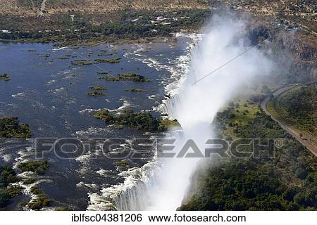 Aerial View, Zambezi river flows into the Victoria Falls, border of Zambia and Zimbabwe, Africa View Large Photo Image Stock Photograph - Aerial View, Zambezi river flows into the Victoria Falls, border of Zambia and Zimbabwe, Africa. Fotosearch