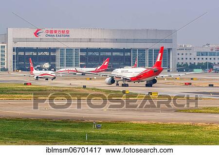 Airbus and Boeing aircraft of Shanghai Airlines at Shanghai Airport, China, Asia View Large Photo Image Stock Photo - Airbus and Boeing aircraft of Shanghai Airlines at Shanghai Airport, China, Asia. Fotosearch