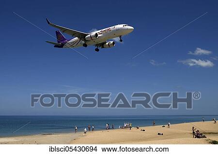 Aircraft of the company Smile Air, landing approach, Mai Kao Beach, Phuket, Thailand, Asia View Large Photo Image Picture - Aircraft of the company Smile Air, landing approach, Mai Kao Beach, Phuket, Thailand, Asia. Fotosearch