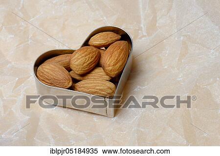Stock Photography - Almonds in cookie cutter( Prunus dulcis), sweet almond. Fotosearch
