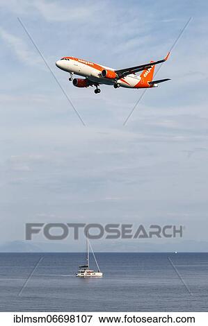 Stock Photo - An Airbus A320 aircraft of EasyJet with registration number OE-IVE at Corfu Airport, Greece, Europe. Fotosearch