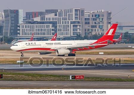 An Airbus A330-300 aircraft of Shanghai Airlines with registration number B-6097 at Shanghai airport, China, Asia View Large Photo Image Stock Photograph - An Airbus A330-300 aircraft of Shanghai Airlines with registration number B-6097 at Shanghai airport, China, Asia. Fotosearch