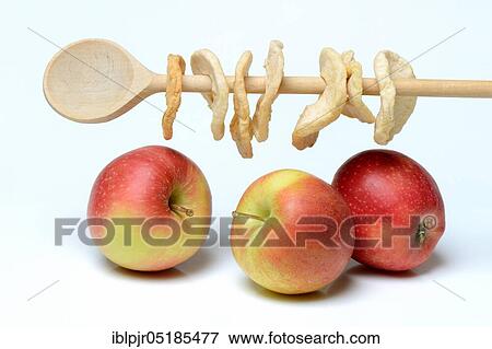Stock Photo - Apples and apple rings on wooden spoon. Fotosearch