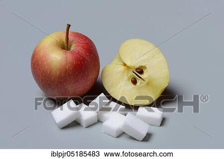 Stock Image - Apples and sugar cubes, apple, sugar consumption, white sugar, beet sugar. Fotosearch