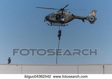 Armed policeman abseiling from helicopter onto roof, body armour, machine gun, Lucerne police, Luchs special operations group during an exercise, Switzerland, Europe View Large Photo Image Stock Image - Armed policeman abseiling from helicopter onto roof, body armour, machine gun, Lucerne police, Luchs special operations group during an exercise, Switzerland, Europe. Fotosearch