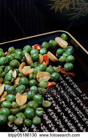 Stock Image - Asian snacks in shell, peanuts, green peas, chili. Fotosearch