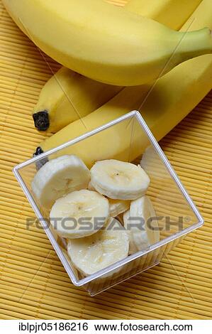 Stock Photograph - Banana slices in peel and bananas. Fotosearch