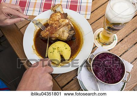 Stock Image - Bavarian cuisine, Weissbier, pork, potato dumplings, red cabbage, Hotel Post, Mittenwald, Bavaria, Germany, Europe. Fotosearch