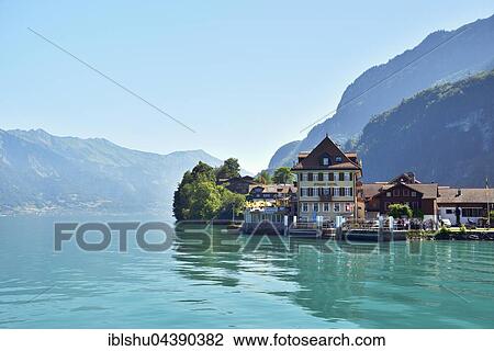 Stock Image - Beach hotel with jetty, Iseltwald, Lake Brienz, Canton of Bern, Switzerland, Europe. Fotosearch