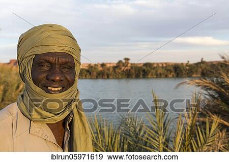 Beduin at the shore of Ounianga kebir part of the the Unesco sight Ounianga lakes, northern Chad, Africa View Large Photo Image Stock Photo - Beduin at the shore of Ounianga kebir part of the the Unesco sight Ounianga lakes, northern Chad, Africa. Fotosearch