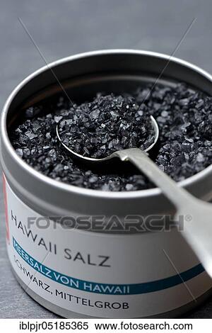 Stock Photography - Black Hawaiian salt with spoon in tin, salt, lava salt, sea salt with activated carbon. Fotosearch