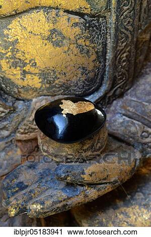 Black stone with gold plate in hand of Buddha View Large Photo Image Stock Image - Black stone with gold plate in hand of Buddha. Fotosearch