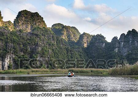 Stock Photo - Boating, Limestone mountains, Trang An Scenic Landscape Complex, UNESCO world natural heritage, Vietnam, Asia. Fotosearch