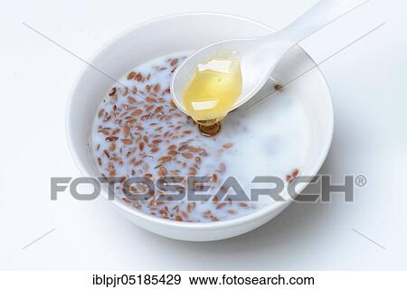 Bowl of swollen flax seed and spoonful of honey, flax swollen in water and milk, Common flax ( Linum usitatissimum) View Large Photo Image Stock Photo - Bowl of swollen flax seed and spoonful of honey, flax swollen in water and milk, Common flax ( Linum usitatissimum). Fotosearch