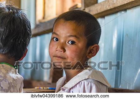Stock Photograph - Boy looking at camera, pupil at school, Shan State, Myanmar, Asia. Fotosearch