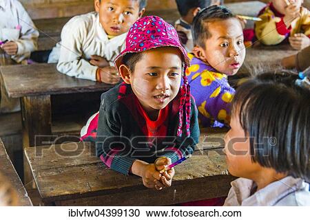 Boy sitting at desk, pupil at school, Shan State, Myanmar, Asia View Large Photo Image Stock Image - Boy sitting at desk, pupil at school, Shan State, Myanmar, Asia. Fotosearch