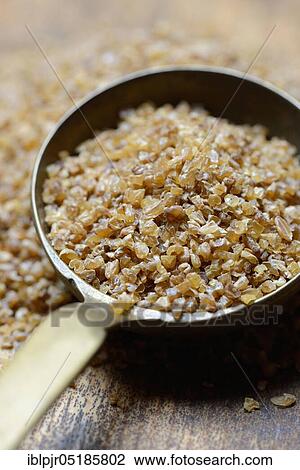 Stock Image - Bulgur, bulgur wheat in ladle, pre-cooked durum wheat. Fotosearch