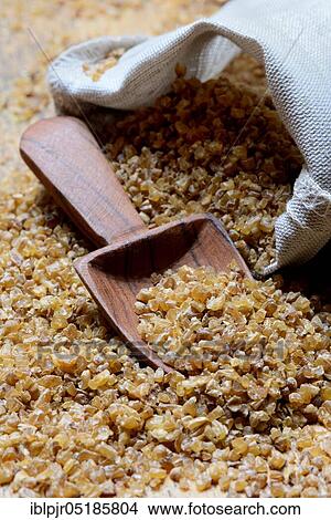 Bulgur, bulgur wheat with wooden shovel, pre-cooked durum wheat View Large Photo Image Picture - Bulgur, bulgur wheat with wooden shovel, pre-cooked durum wheat. Fotosearch