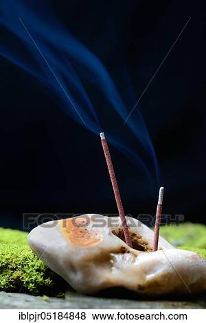 Burning incense sticks stuck in stone, incense candle View Large Photo Image Stock Photo - Burning incense sticks stuck in stone, incense candle. Fotosearch