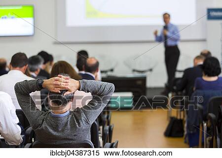 Stock Photography - Business man during a conference presentation. Fotosearch