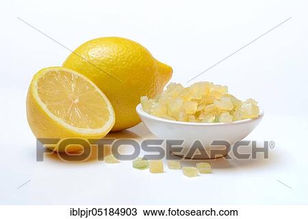 Stock Image - Candied lemon peel cubes and lemon. Fotosearch