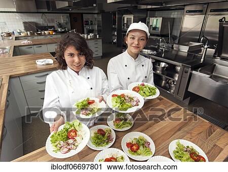 Canteen kitchen in a vocational college in Düsseldorf, trainees manage the school's catering as part of their training, trainees prepare salad plates, Düsseldorf, Germany, Europe View Large Photo Image Stock Image - Canteen kitchen in a vocational college in Düsseldorf, trainees manage the school's catering as part of their training, trainees prepare salad plates, Düsseldorf, Germany, Europe. Fotosearch
