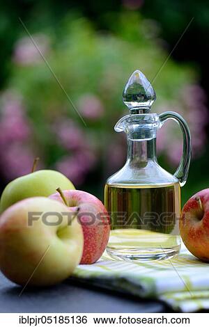 Carafe with apple vinegar and apples View Large Photo Image Stock Photograph - Carafe with apple vinegar and apples. Fotosearch