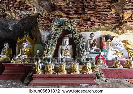 Stock Image - Cave filled with buddhas, Kawgun cave, Hpa-An, Kayin state, Myanmar, Asia. Fotosearch