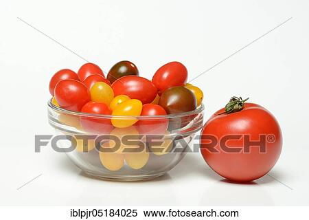 Stock Photography - CherryTomatoes (Solanum lycopersicum) in glass bowl. Fotosearch