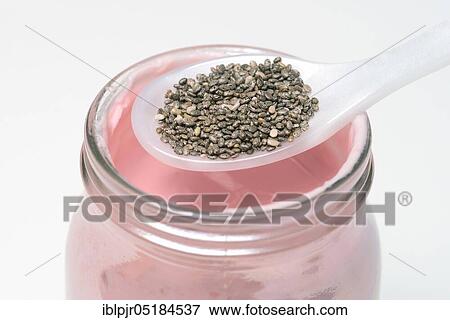 Stock Photo - Chia seeds ( Salvia hispanica) on spoon, yoghurt. Fotosearch