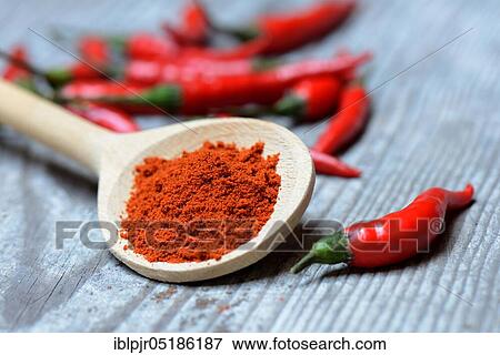 Stock Photo - Chili, chili powder in wooden spoons and chili peppers ( Capsicum annuum). Fotosearch