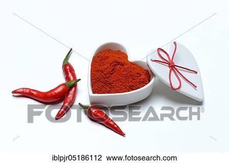 Stock Image - Chili powder in bowl with heart shape, chili peppers( Capsicum annuum), I love chili. Fotosearch